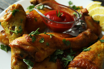 Roast chicken drumsticks, spices and sauce, close up