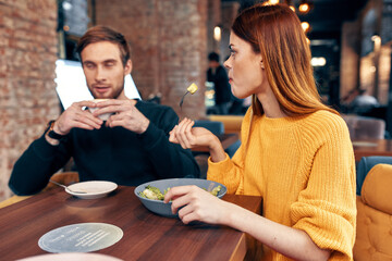 emotional men and women at a table in a cafe fun married couple meal salad
