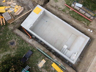 aerial drone shot of pool construction site almost finished spackling from above in a garden