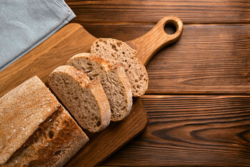 Fresh bread and slices on cutting board