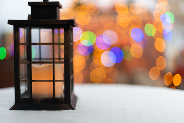 Old hand lantern with barely smoldering candle inside. On the second burn the background is blurred...