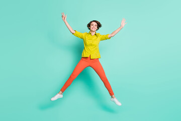 Fototapeta na wymiar Full length body size photo of smiling girl playful childish jumping like star isolated vibrant teal color background