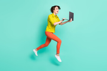 Full length body size photo of jumping female freelancer using laptop isolated vibrant turquoise color background