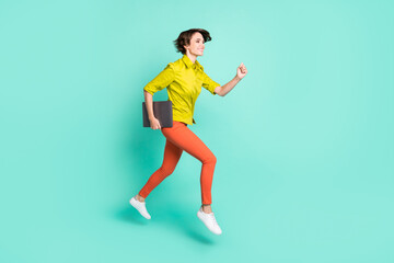 Fototapeta na wymiar Full length body size photo of jumping female programmer running fast keeping computer isolated vivid teal color background