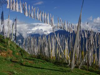 Beautiful mountain landscape of snow-capped Kangchenjunga range seen through buddhist prayer flags and banners in Pelling, Sikkim, India