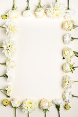 Fototapeta na wymiar White fresh flowers arrangement with blank space for text. Romantic invitation for wedding, birthday or anniversary. Creative floral backdrop with copy space. Flat lay, top view.