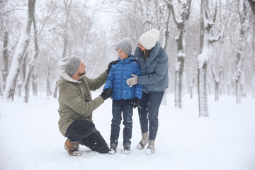 Fototapeta na wymiar Family spending time outside on winter day. Christmas vacation