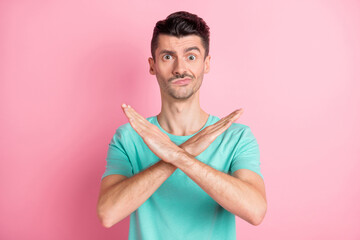Photo of young unhappy man crossed hands no stop gesture decline ban block isolated over pink color...