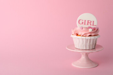 Baby shower cupcake with Girl topper on pink background, space for text