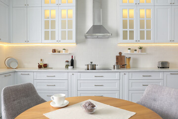 Elegant kitchen interior with stylish furniture and modern stove