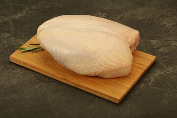 Raw whole chicken breast with skin