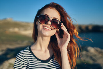 happy woman on the beach in the mountains near the river high cliffs landscape fresh air