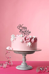 Beautifully decorated birthday cake on pink background