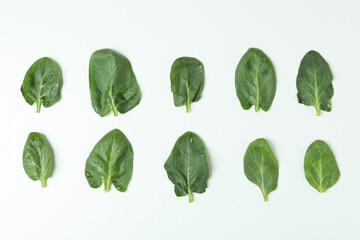 Fresh raw spinach leaves on white background