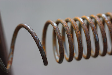 semi-stretched rusty steel spring close-up view