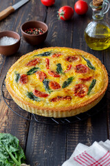 Quiche or pie with tomatoes, spinach and cheese. Healthy eating. Vegetarian food. French cuisine.