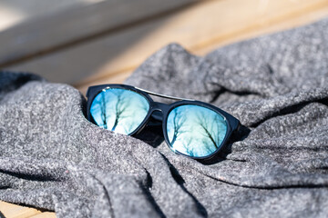 Fashion Sunglasses design with blue lenses shoot outside in a summer day closeup. Selective focus....