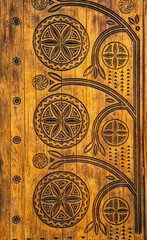 Fototapeta na wymiar Poltava, Ukraine - April 14, 2021: beautiful wooden door with a carved floral pattern in the Ukrainianhistorical building in the Ukrainian Art Nouveau style. Museum of Local Lore in Poltava, Ukraine