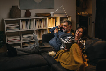 middle age couple enjoying time at home. evening scene
