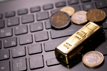 money coins on laptop computer