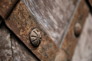 Fragment of the old iron door. Old medieval metal gate background.
