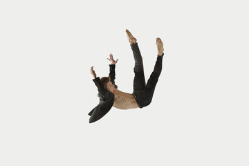 Man in casual style clothes jumping and dancing isolated on white background. Art, motion, action,...