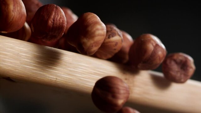Close up of hazelnuts falling from a cutting table