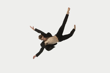 Man in casual style clothes jumping and dancing isolated on white background. Art, motion, action, flexibility, inspiration concept. Flexible caucasian ballet dancer.