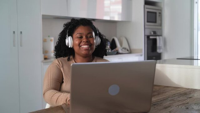 Happy Latin woman having fun doing video call using laptop at home - Technology and communication concept