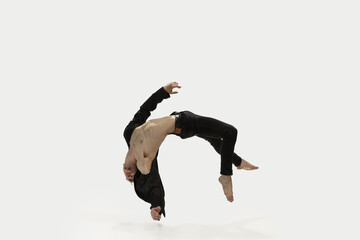 Man in casual style clothes jumping and dancing isolated on white background. Art, motion, action,...