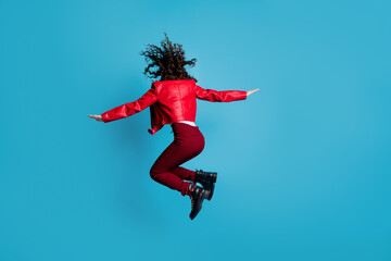 Fototapeta na wymiar Full size back photo of hooray girl jump wear red jacket trousers boots isolated on blue background