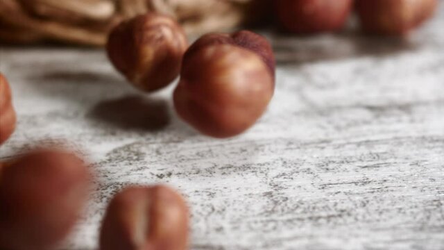 Hazelnuts rolling on a table