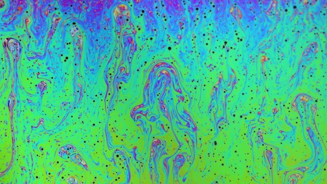 Psychedelic abstract colours and patterns reflecting on a soap bubble.