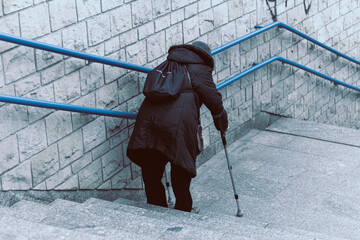 older woman on the city stairs © konrad hryciuk