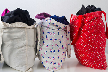 Reusable cloth bags filled with clothes