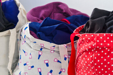 Reusable cloth bags filled with clothes