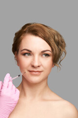 Lips injection at spa salon. Doctor hands. Pretty female patient. Beauty treatment. Healthy skin...