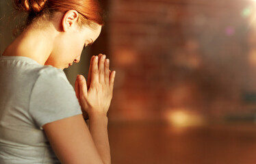 religion, faith and people concept - close up of woman meditating at yoga studio