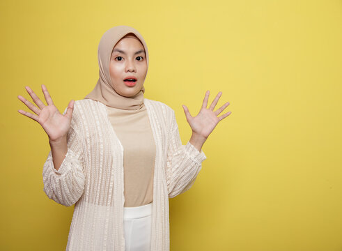 hijab women with shocked expression at the camera isolated on a yellow background