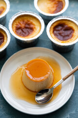 Flan or creme caramel on a blue rough background
