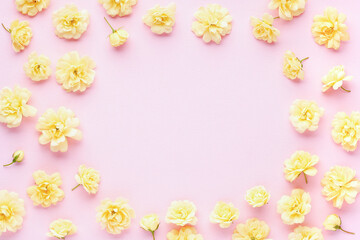 Flowers composition. Yellow rose  flowers on pink background. Womens, mothers dayconcept. Wedding card. Flat lay, top view  , copy space
