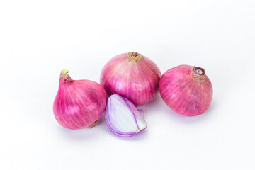 Shallots and pieces of peel are put on white table as background. It is a Thai onion, Thai herb.