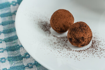 truffles with cocoa, coconut and sesame seeds with chocolate and marshmallows, delicious dessert on a white background