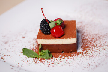 Fruit pudding with delicate cottage cheese covered with fresh raspberries. Closeup dessert on a white plate on the background of the pool