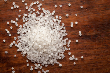 Macro Close up of organic white sago or sabudana small size cleaned on wooden top background.