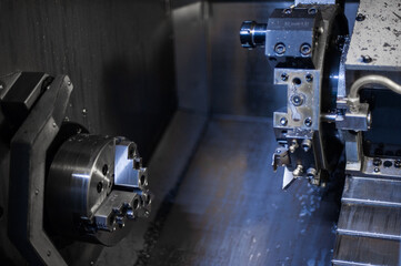 The CNC lathe machine. Turning machine for drilling with the drill tool and center drill tool .The hi-technology machining. CNC milling machine for working and producing a metal detail. Rotating head 