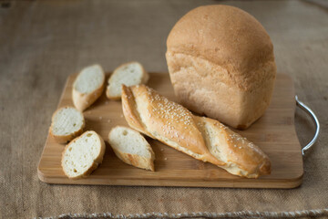 bread fresh whole and sliced on a wooden board