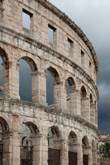 Obraz premium Pula Arena, historic Roman amphitheater in Pula, Croatia on stormy skies background