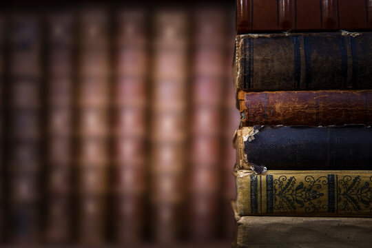 Old books on wooden shelf. Bookshelf history theme grunge background.