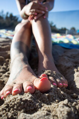 Woman feet on the sand